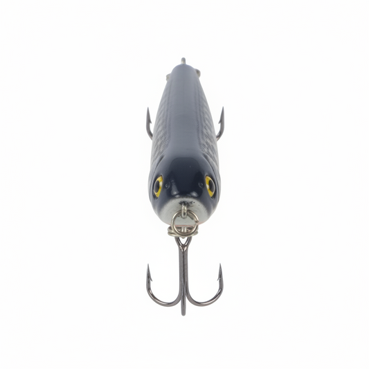Surface walking-dog fishing lure, front view, dark blue speckled body, yellow eyes, treble hooks