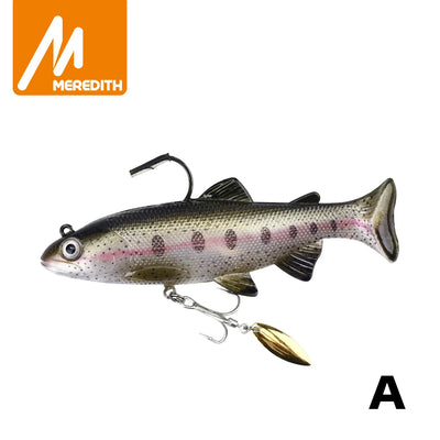 Soft swimbait lure with gray-pink speckled body, gold spinner blade and treble hook