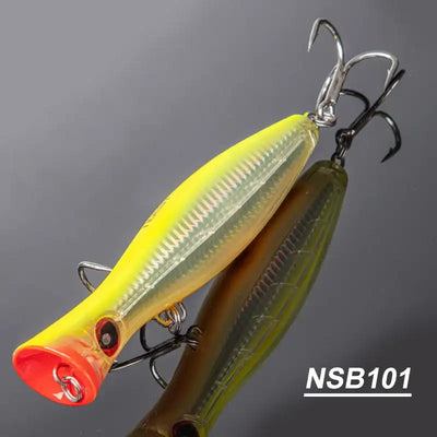 Hard fishing popper lure with yellow top and dark olive body, red lip, treble hooks (NSB101)