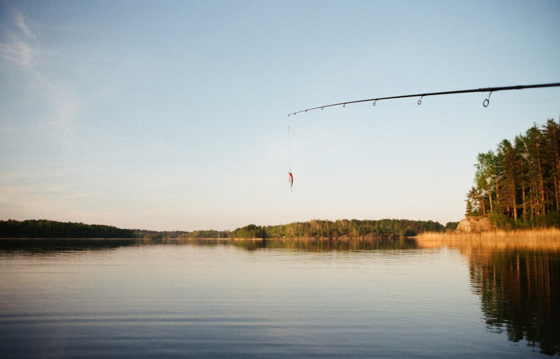 Fishing tackle and lures laid out beside a body of water in Australia