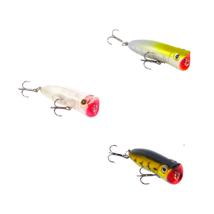Set of three surface popper lures: white, yellow, and black with treble hooks