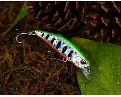 Green and silver sinking minnow crankbait with black spots and treble hooks