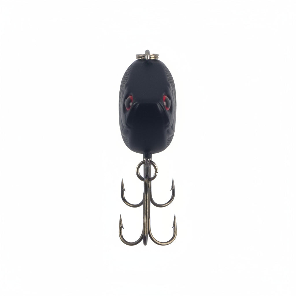 Lipless crankbait lure, dark oval body with red eyes and two treble hooks