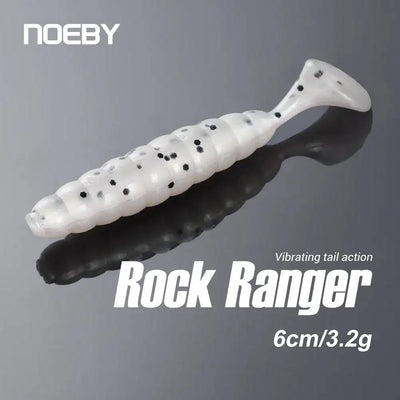 Artificial silicone swimbait lure, white with black speckles and ribbed body, soft paddle tail
