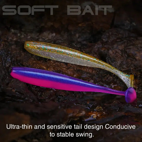 Soft T-tail worm lure in gold-sparkle with purple second lure on rocky surface