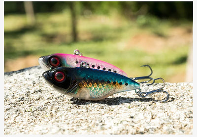 Fishing crankbait lure with blue-green scale pattern and two treble hooks