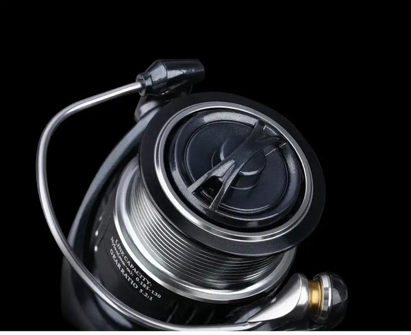Spinning reel spool with silver ridged line spool and black rotor, viewed close-up