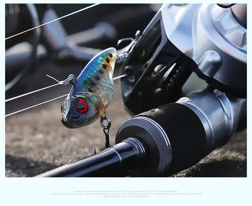 Blue and black sinking crankbait lure with red eyes and two treble hooks.