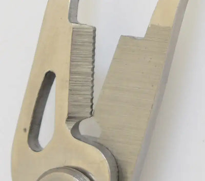 Close-up of stainless steel fishing line cutter jaws and spring hinge