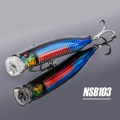 Two topwater feed popper lures, blue and red striped bodies, treble hooks, NSB103