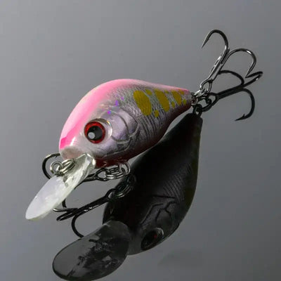Floating crankbait lure with pink-gray body, red eye, clear lip, treble hooks