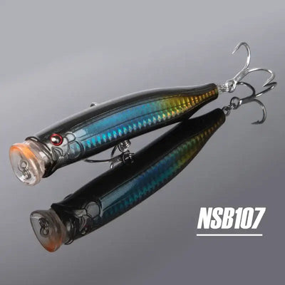 Two topwater feed popper lures, black and blue striped finish, treble hooks, NSB107