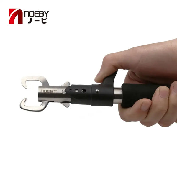 Black hook remover pliers held in hand, silver jaw tool for removing hooks