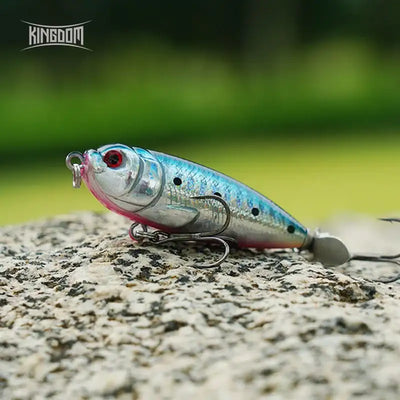 Blue and silver topwater pencil lure with black spots, red eye, and treble hooks
