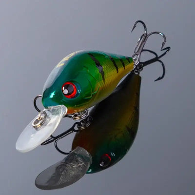 Green and white crankbait fishing lure with clear lip and treble hooks