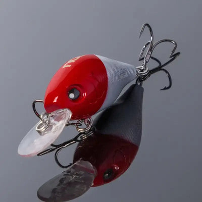 Red and white crankbait fishing lure with clear lip and treble hooks