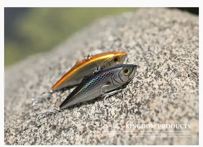 Fishing lure, gold and silver with black back and red mouth, on metal double hooks