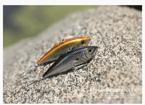 Fishing lure, gold and silver with black back and red mouth, on metal double hooks