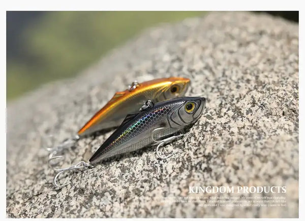 Fishing lure, gold and silver with black back and red mouth, on metal double hooks