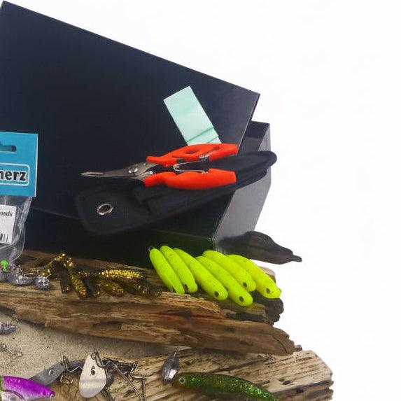 Fishing tackle box with red lures and green soft plastic worms
