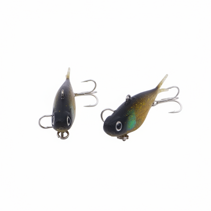 Two gold glitter fishing lures with dark blue bodies, treble hooks, and pointed tails