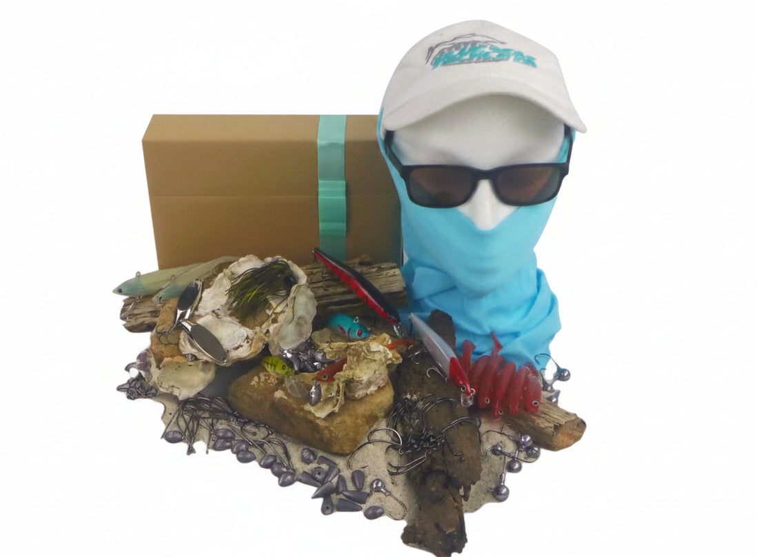 Fishing tackle gift box with assorted lures, baits, and red rubber lure