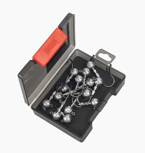 Triple-edge lead head jig hooks in a black tackle box with foam insert