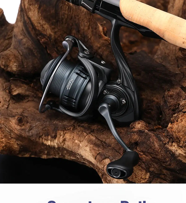 Black spinning fishing reel with crank handle and ridged spool, resting on rock