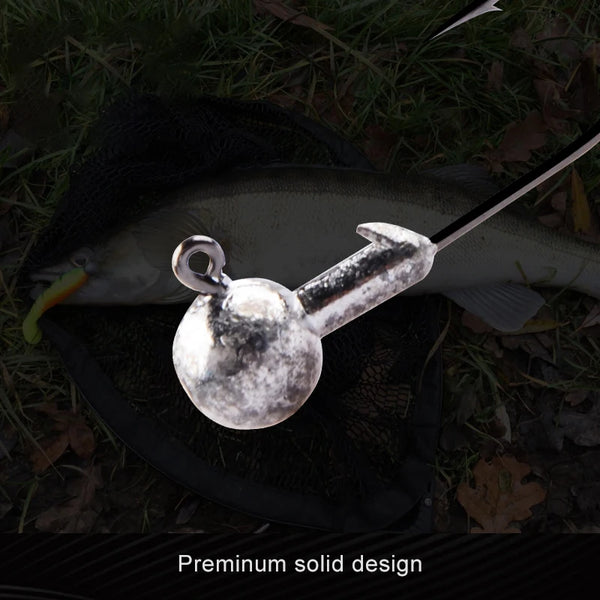 Three round ball jig heads with curved hooks, speckled silver balls