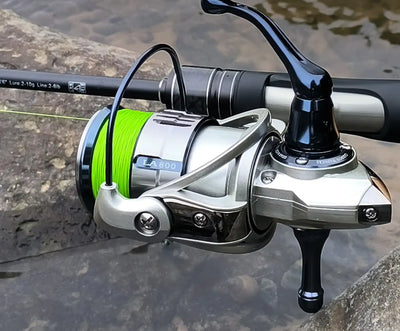 Green braided fishing line on spinning reel with line spooled on the spool