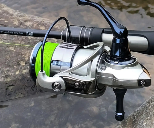 Green braided fishing line on spinning reel with line spooled on the spool