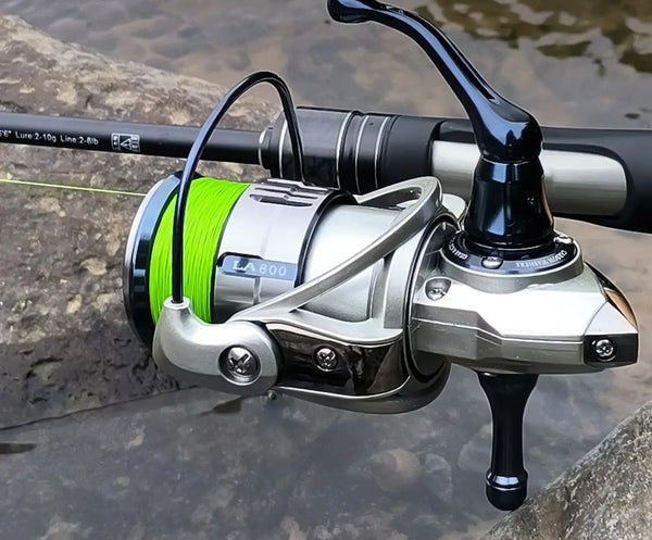 Green braided fishing line on spinning reel with line spooled on the spool