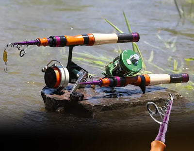 Telescopic fishing rod with orange and black accents and fishing line guides