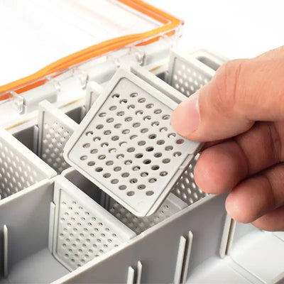 Gray perforated insert panel in divided fishing tackle box compartment