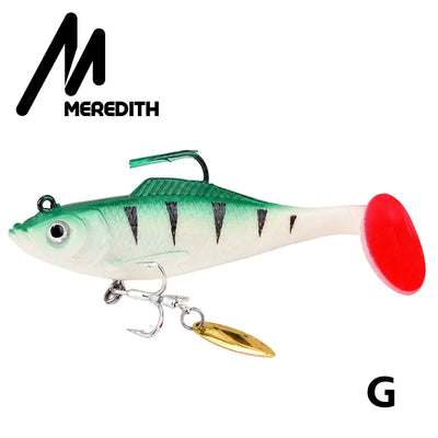 Green soft plastic swimbait lure with red tail and gold spinner blade