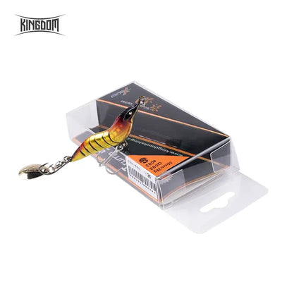 Metal spinner shrimp fishing lure in clear retail box, yellow-gold body with spoon blade