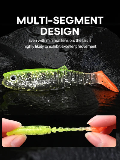 Speckled paddle tail swimbait in green with clear back and orange tail.
