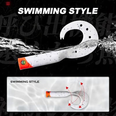 White soft lure with black speckles and orange head, curved tail trailer.