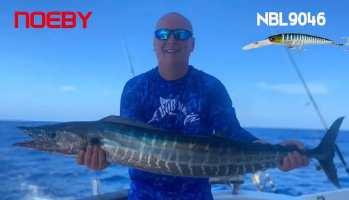 Angler holding a fish caught during trolling with a minnow-style wobbler lure