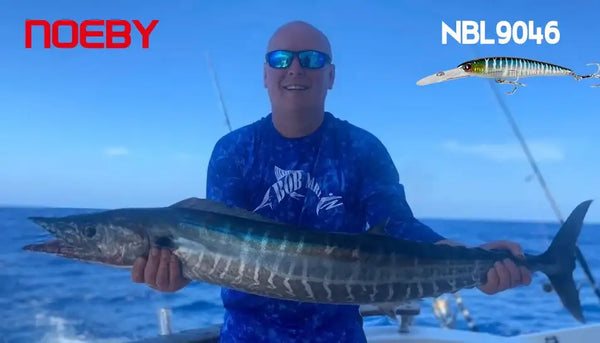 Angler holding a fish caught during trolling with a minnow-style wobbler lure