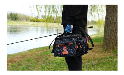 Black fishing tackle bag worn as a crossbody shoulder bag with multiple front compartments