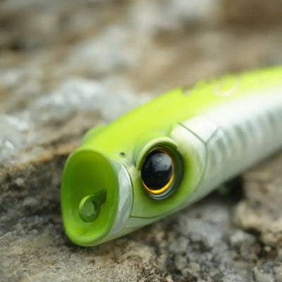 Neon green and white floating topwater popper lure with round front and treble hook