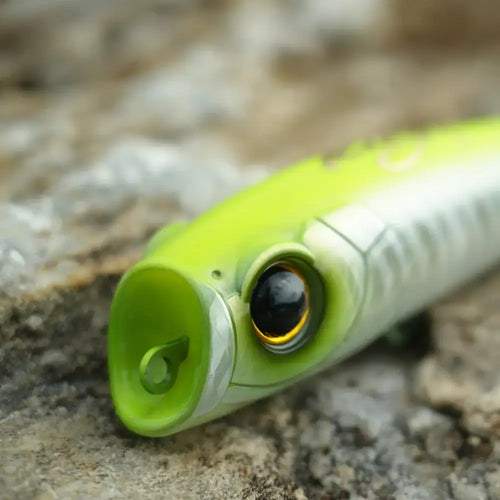 Neon green and white floating topwater popper lure with round front and treble hook