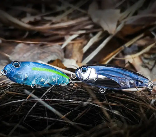 Topwater stickbait fishing lure pair, blue with silver accents and treble hooks