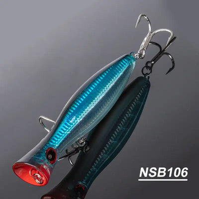 Teal blue topwater popper hard bait with red face and treble hooks