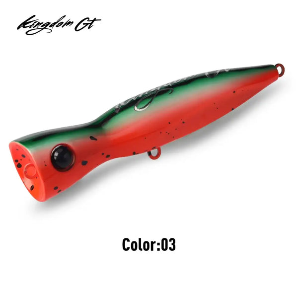 Red and green topwater popper fishing lure with black speckles and treble hook hardware