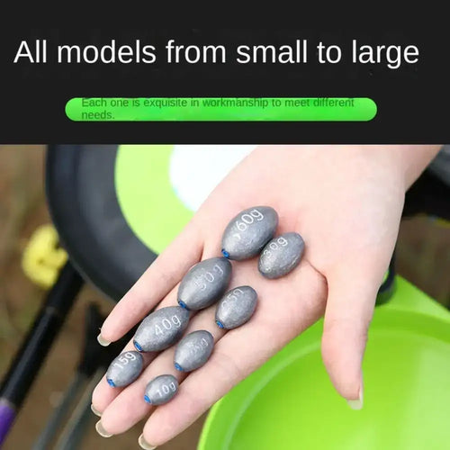 Assorted gray olive lead sinkers with blue ends held in a hand, multiple weights