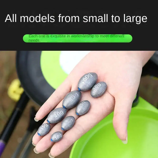 Assorted gray olive lead sinkers with blue ends held in a hand, multiple weights