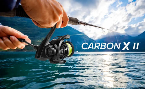 Spinning fishing reel on rod, outdoors near water with hands holding line