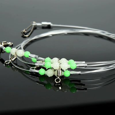 Fishing leader rig set with green and white beads and multiple metal swivel hooks